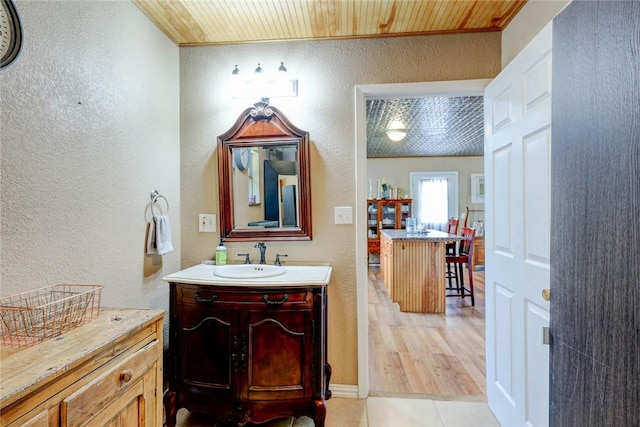 1820 16th St, Rockport, TX 78382 - bathroom with ornamental molding, tile patterned floors, vanity, and a textured wall