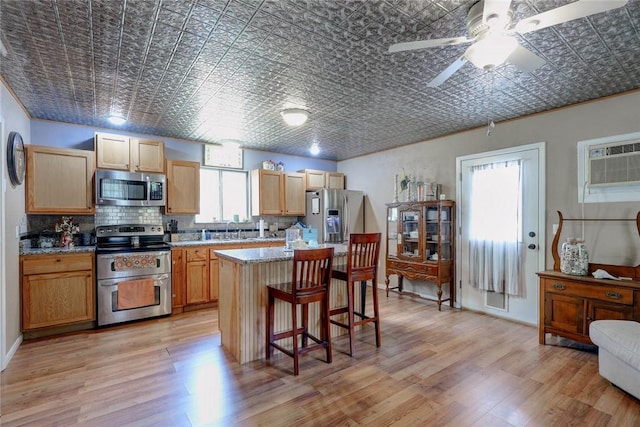 1820 16th St, Rockport, TX 78382 - kitchen with tasteful backsplash, a center island, a wall mounted air conditioner, appliances with stainless steel finishes, and an ornate ceiling