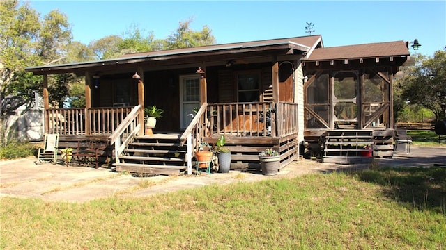 1820 16th St, Rockport, TX 78382 - view of front facade with a porch and a sunroom