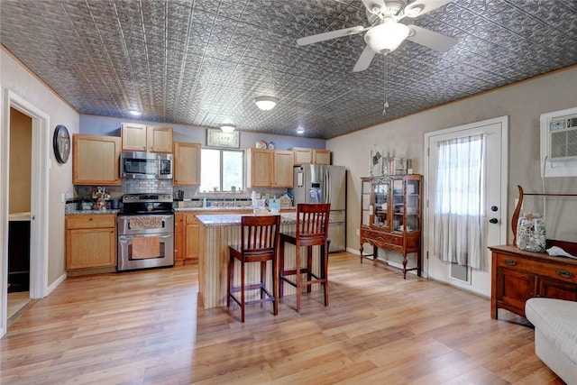 1820 16th St, Rockport, TX 78382 - kitchen with light countertops, backsplash, an ornate ceiling, a breakfast bar area, and stainless steel appliances