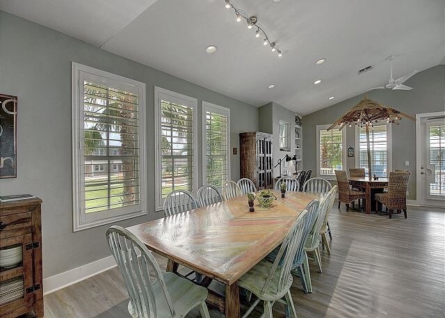 dining room with ceiling fan, a healthy amount of sunlight, vaulted ceiling, and french doors