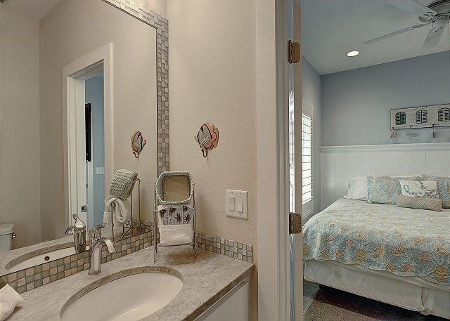 bedroom with ceiling fan and sink