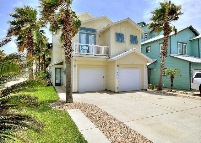 view of front of house with a garage and a balcony