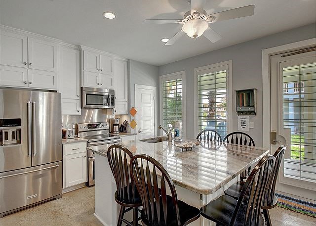 dining room with ceiling fan and sink