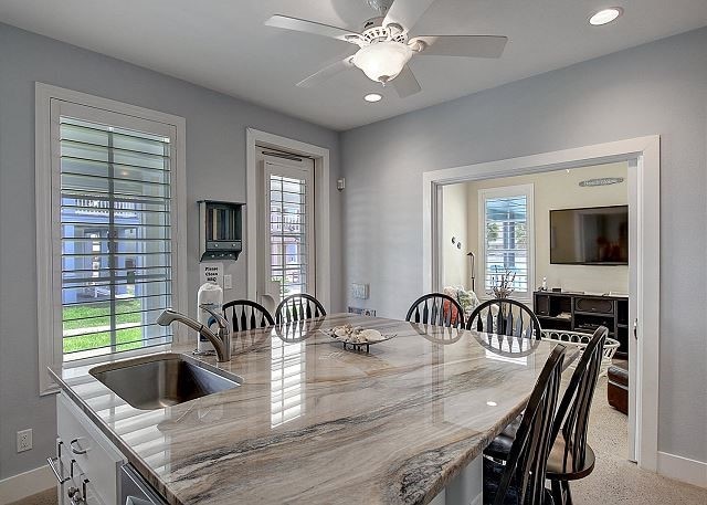 dining area with ceiling fan, sink, and a healthy amount of sunlight