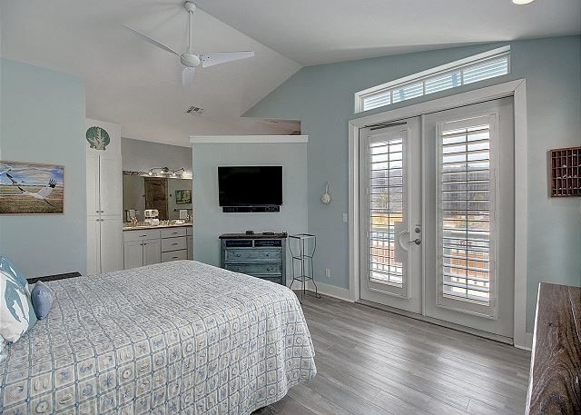 903 Banyan Beach Dr, Port Aransas, TX 78373 - bedroom with french doors, access to outside, vaulted ceiling, wood finished floors, and baseboards