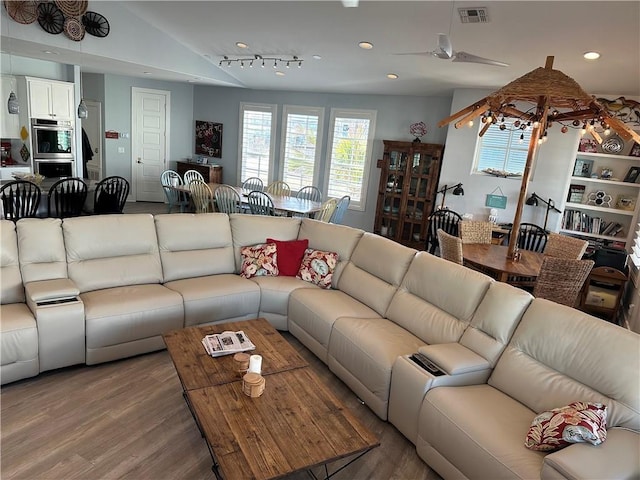 living room featuring ceiling fan, track lighting, lofted ceiling, and hardwood / wood-style floors