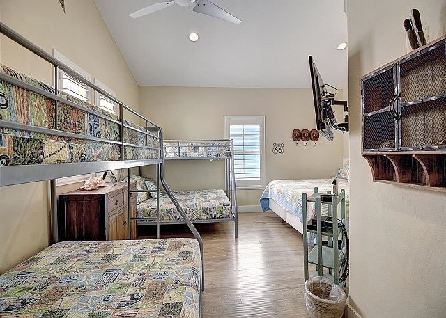 bedroom featuring ceiling fan, lofted ceiling, and hardwood / wood-style flooring