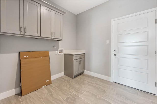 washroom featuring washer hookup and cabinets