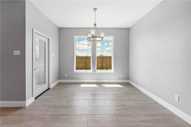 unfurnished dining area featuring a notable chandelier