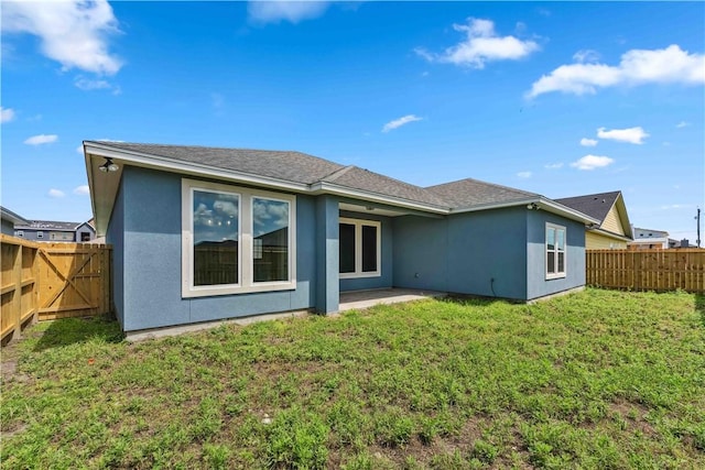 rear view of property with a lawn