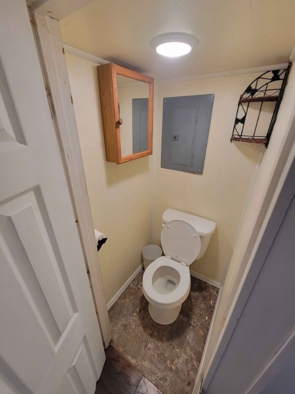 bathroom with toilet and electric panel