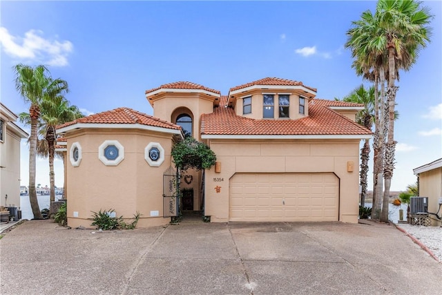 mediterranean / spanish-style home featuring central AC unit