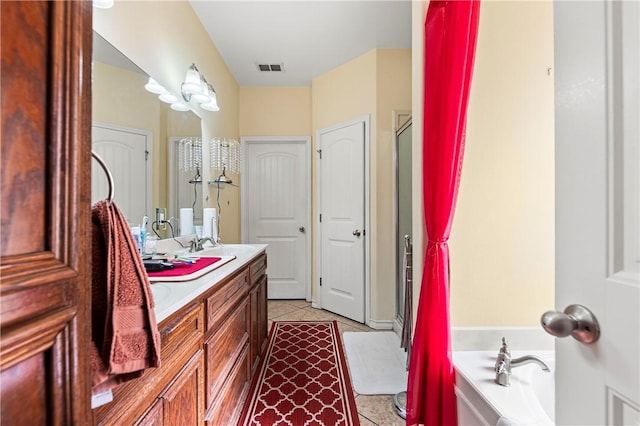 bathroom with tile patterned flooring, vanity, and plus walk in shower