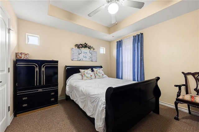 bedroom with carpet floors, a raised ceiling, and ceiling fan