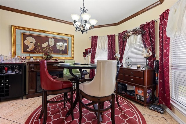 dining space with light tile patterned floors, ornamental molding, and a chandelier