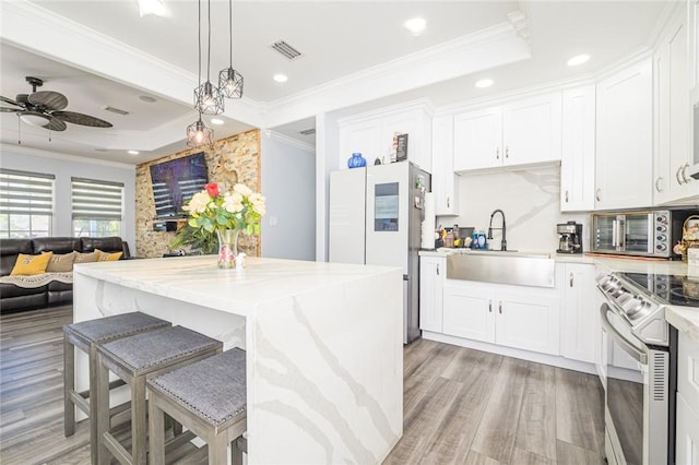 2774 Dallas Ave, Ingleside, TX 78362 - kitchen with freestanding refrigerator, electric range, light wood finished floors, a sink, and crown molding