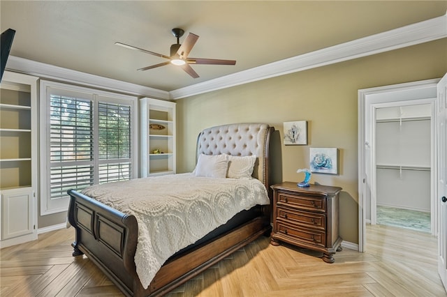 bedroom with a closet, a walk in closet, light parquet flooring, and ceiling fan