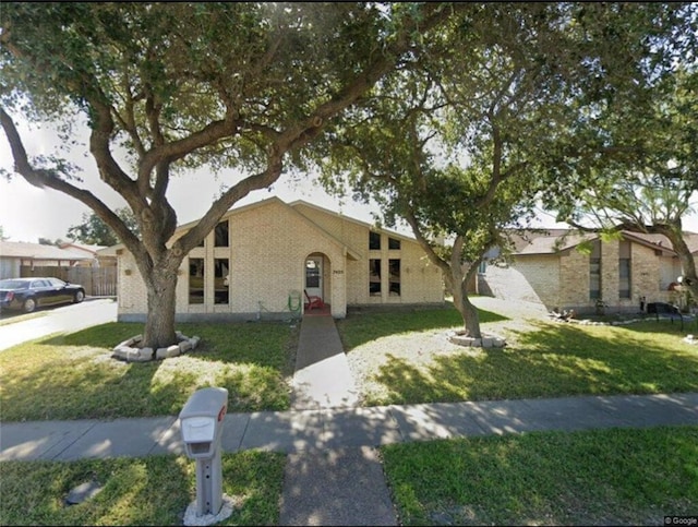 7405 Convair Dr, Corpus Christi, TX 78412 - mid-century home featuring a front lawn and brick siding