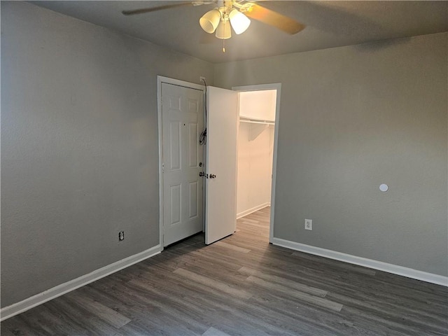 4134 Sierra St, Corpus Christi, TX 78410 - unfurnished bedroom featuring dark wood-type flooring, a spacious closet, a closet, and ceiling fan