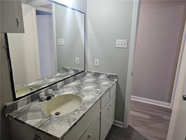 4134 Sierra St, Corpus Christi, TX 78410 - bathroom with wood finished floors, vanity, and a textured wall
