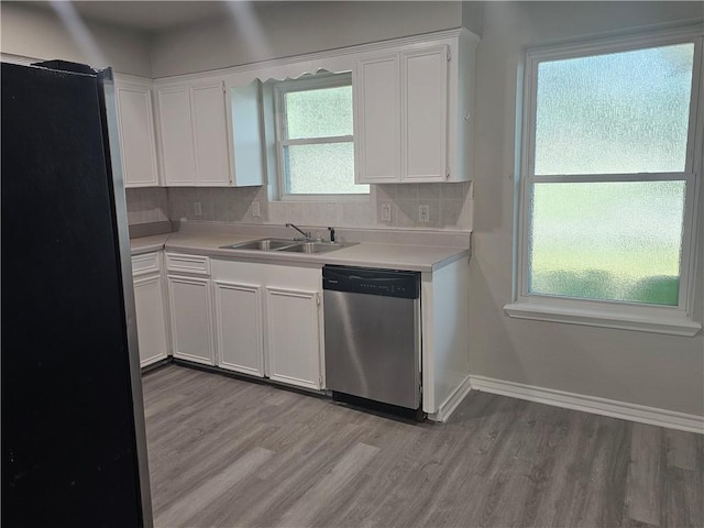 4134 Sierra St, Corpus Christi, TX 78410 - kitchen featuring stainless steel appliances, light wood-style floors, light countertops, white cabinetry, and backsplash
