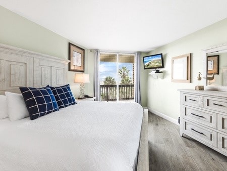 bedroom with access to exterior and light hardwood / wood-style flooring