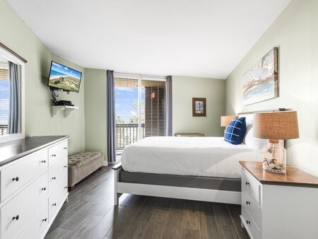 bedroom with dark wood-type flooring