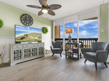 sitting room featuring hardwood / wood-style floors and ceiling fan