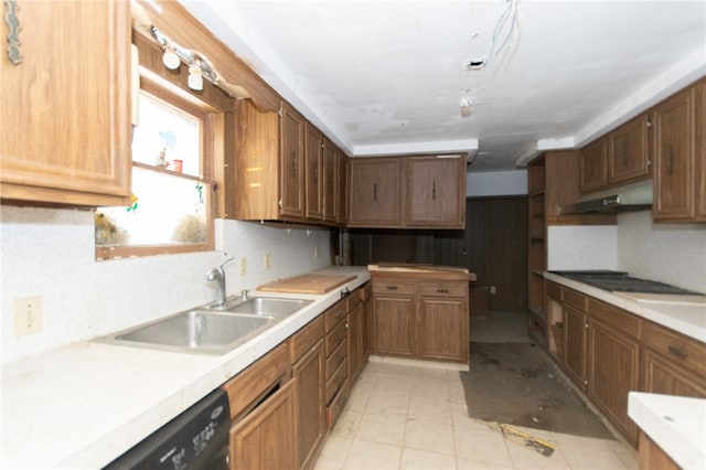 kitchen featuring light tile patterned floors, sink, and dishwasher