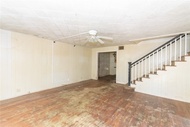 basement with hardwood / wood-style flooring and ceiling fan