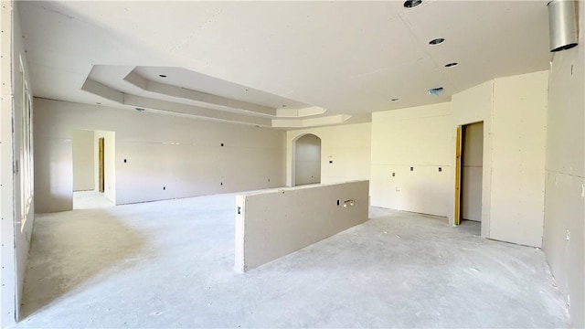 7617 Roman Dr, Corpus Christi, TX 78414 - empty room with unfinished concrete flooring and a tray ceiling