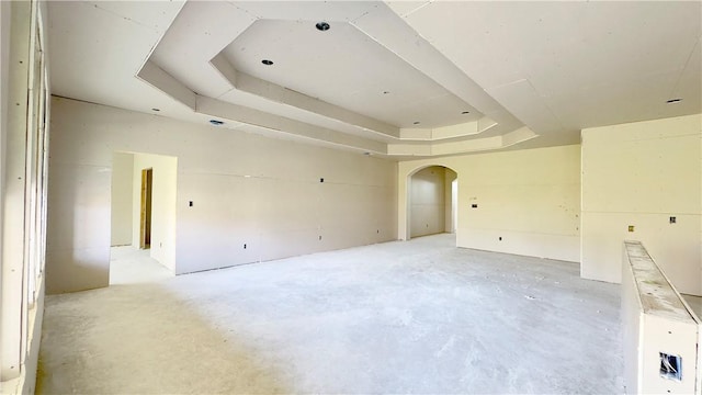 7617 Roman Dr, Corpus Christi, TX 78414 - spare room with unfinished concrete floors, a tray ceiling, and arched walkways