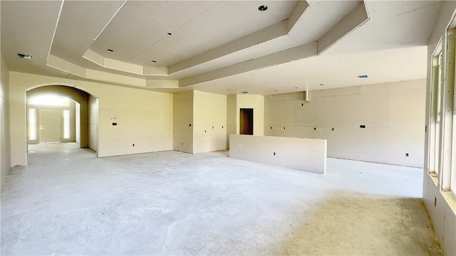 7617 Roman Dr, Corpus Christi, TX 78414 - unfurnished room featuring concrete floors, a raised ceiling, and arched walkways