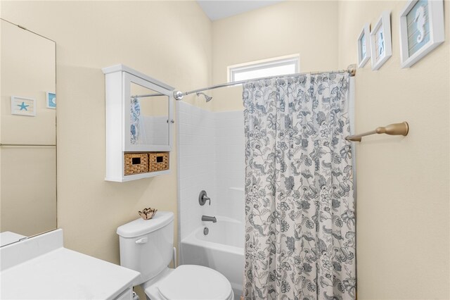 full bathroom featuring shower / bath combo, vanity, and toilet