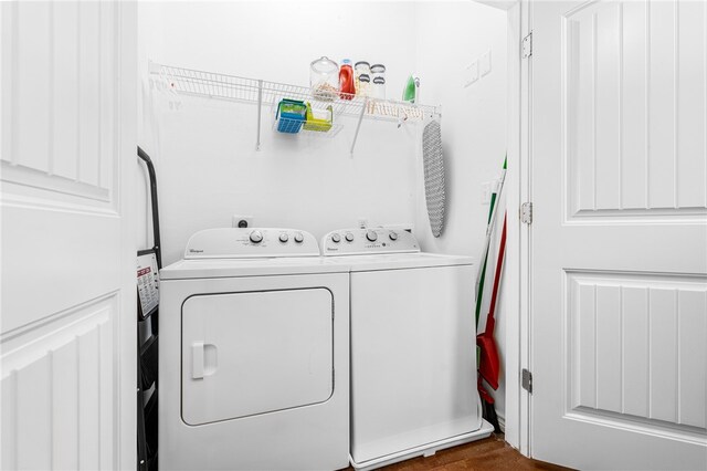 washroom featuring independent washer and dryer and dark hardwood / wood-style floors