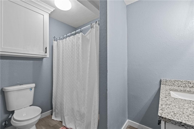 bathroom featuring vanity, hardwood / wood-style floors, and toilet