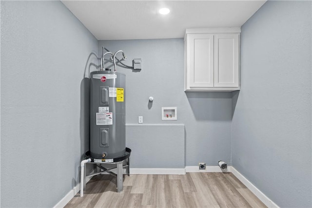 clothes washing area with cabinets, light hardwood / wood-style flooring, hookup for a washing machine, electric water heater, and electric dryer hookup