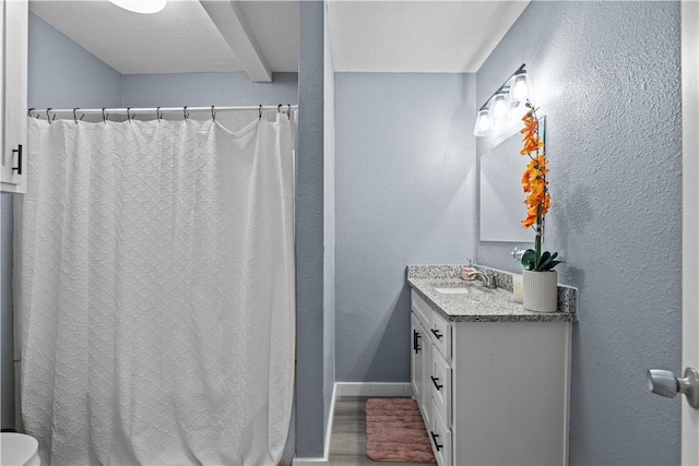 bathroom with vanity and wood-type flooring