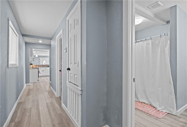 corridor featuring light hardwood / wood-style floors