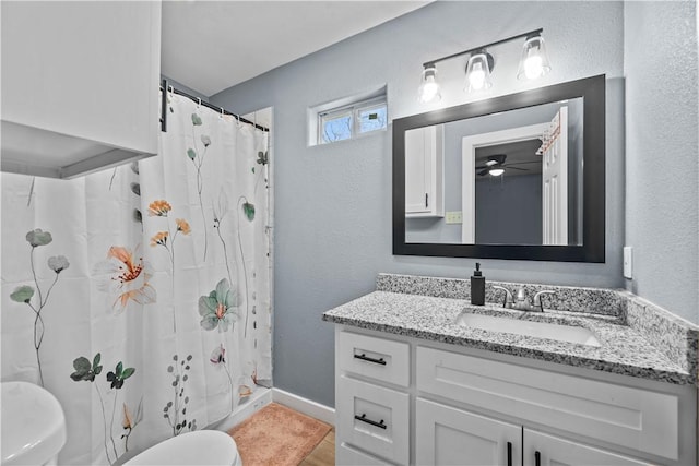 bathroom featuring a shower with curtain, vanity, and toilet