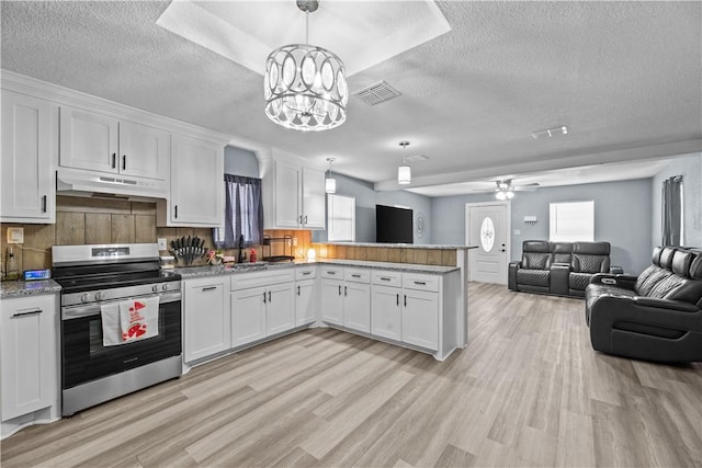 kitchen featuring white cabinetry, stainless steel electric stove, hanging light fixtures, and sink