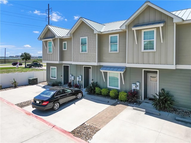 14307 Ridley Way, Corpus Christi, TX 78418 - multi unit property with board and batten siding, a standing seam roof, metal roof, central air condition unit, and fence