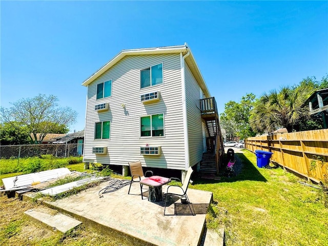 back of property with a balcony, a yard, and a patio