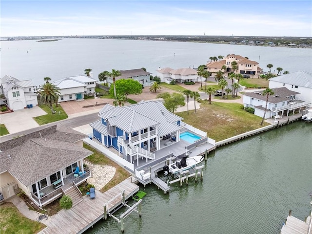 drone / aerial view featuring a water view and a residential view