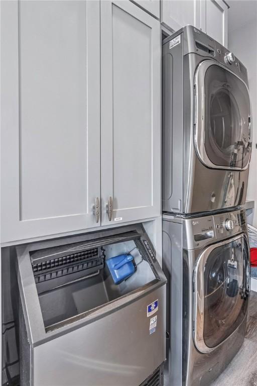 laundry area with laundry area and stacked washer / drying machine