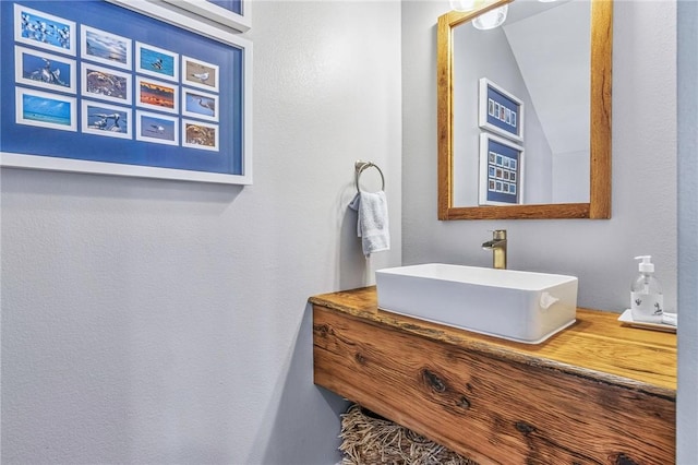 bathroom with lofted ceiling and vanity