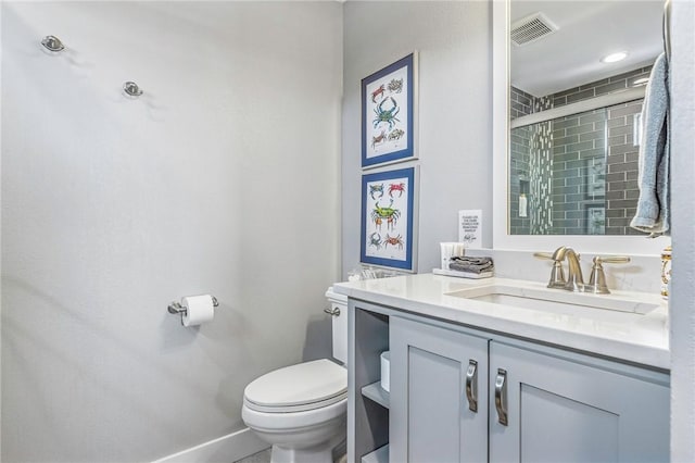 bathroom with visible vents, vanity, baseboards, toilet, and tiled shower
