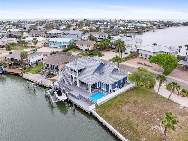 drone / aerial view featuring a water view and a residential view