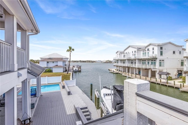 dock area featuring a fenced in pool and a water view